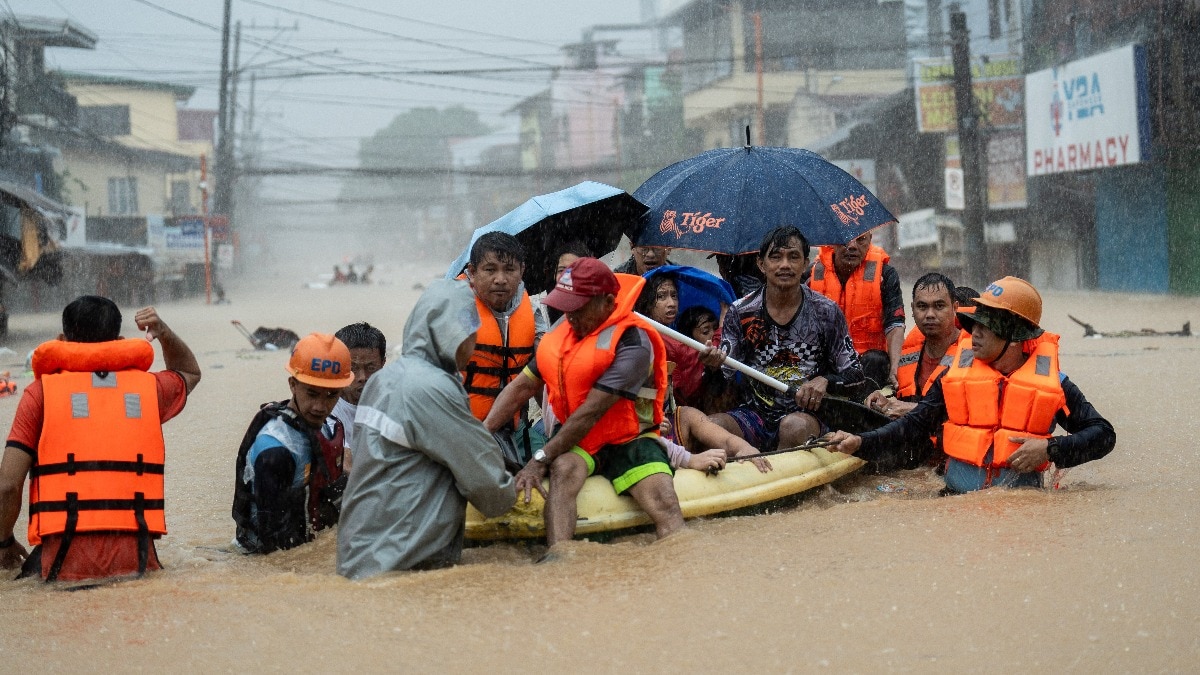 The students had to use umbrellas due to water seeping through cracks in the ceiling of their school in Kushnepalli village